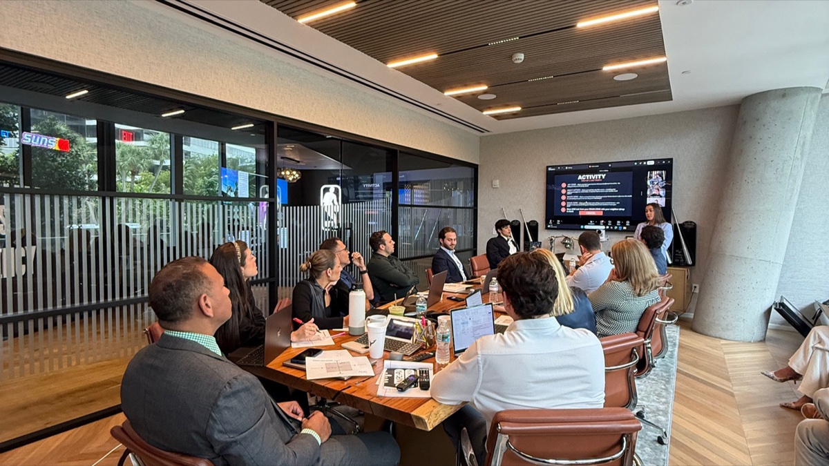 A-Rod Corp leadership team gathered around a long boardroom table during the on-site Prompt-a-thon workshop